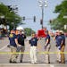 Law enforcement and members of the FBI evidence response team gathered data Tuesday along Central Avenue after Monday’s mass shooting in Highland Pa
