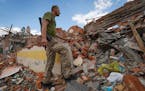 A Ukrainian serviceman looks at the rubble of a school that was destroyed some days ago during a missile strike in outskirts of Kharkiv, Ukraine, Tues