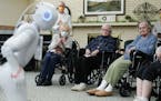 Nursing home residents Carol Jones, Carol Fisher, and Irene Struck listened as Pepper, a new robotic assistant, performed an adult-themed comedy routi