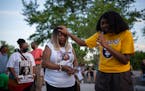 Faith Allen prayed with Philando Castile’s mother, Valerie Castile, at the start of a vigil at the Peace Garden on Larpenteur Avenue in Falcon Heigh