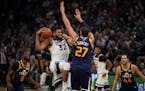 Minnesota Timberwolves center Karl-Anthony Towns (32) drove into Utah Jazz center Rudy Gobert (27) while heading to the rim in the third quarter. ] JE