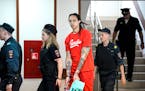 WNBA star and two-time Olympic gold medalist Brittney Griner is escorted to a courtroom for a hearing on Thursday.