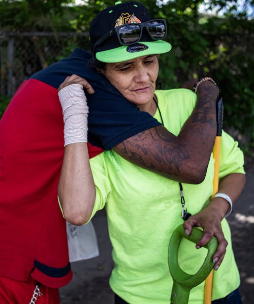 Angel Beaumaster got a hug from “Feenix” for all the good she did looking out for fellow residents in the Near North encampment in Minneapolis on 