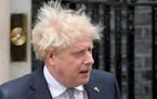 Prime Minister Boris Johnson arrives Thursday to read a statement outside 10 Downing Street in which he said he is formally resigning as Britain’s C