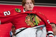 Sam Rinzel pulled on the Blackhawks jersey after Chicago took him 25th overall at the NHL draft Thursday in Montreal.