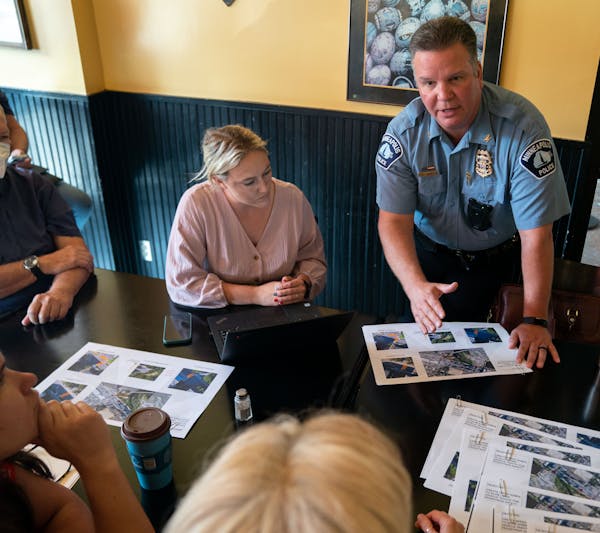 Police Inspector Sean McGinty of the Second Precinct speaks with attendees about safety plans moving forward during a town hall held by Minneapolis Th