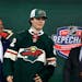 Liam Ohgren, the Wild’s first round draft pick, stood in front of owner Craig Leipold, left, after being chosen at 19 overall on Thursday in Montrea