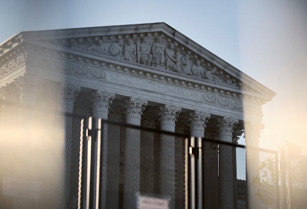 Seen through barricades, the Supreme Court building in Washington, the morning after a ruling overturning Roe v. Wade, on June 25, 2022. 