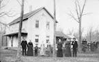 Andrew and Elsa Peterson and their nine children in front of their farmhouse near Waconia, likely in the 1890s.