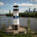 A lighthouse featuring the Park Board logo stands on Hall’s Island beside the Mississippi River. The agency recently restored the historical island,