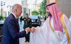In this image released by the Saudi Royal Palace, Saudi Crown Prince Mohammed bin Salman, right, greets President Joe Biden with a fist bump after his