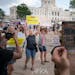 Abortion rights advocates, left, and abortion opponents yelled at each other during a rally at the State Capitol in St. Paul on Sunday.