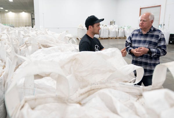 Charles Levine, founder and CEO of Hemp Acres, explains the production process to Gov. Tim Walz on Monday inside the company’s facility in Waconia.