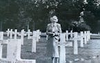 Mary McGowan at the grave of her brother Pvt. William Donnelley at an American cemetery in France.