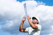 Tony Finau held his trophy after winning the 3M Open last July at TPC Twin Cities in Blaine.
