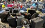 Suitcases are seen uncollected at Heathrow’s Terminal Three baggage reclaim, west of London on July 8, 2022.