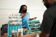 Jailyn Robinson showcased fragrances and incense from Inner Peace Fragrance to an attendee at a Black Business Week kickoff summit at Sabathani Commun