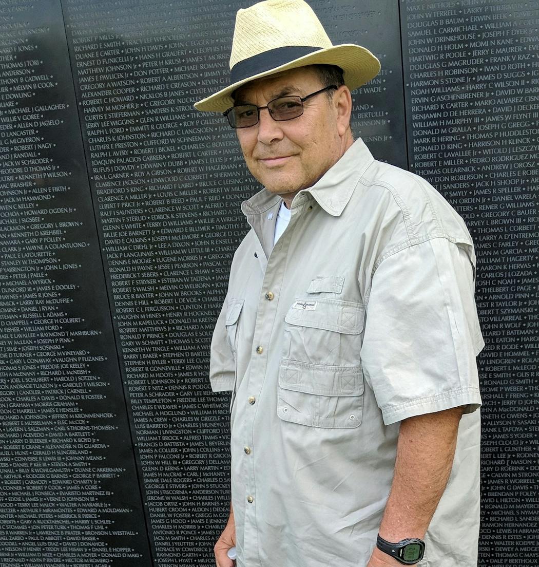 Retired businessman Don St. Dennis, a Vietnam War veteran, standing in front of the replica of the Vietnam War Memorial when it toured Minnesota in 2018.