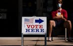 An election judge directs voters outside a polling place in the Pearl Park Recreation Center in Minneapolis on August 11, 2020. 