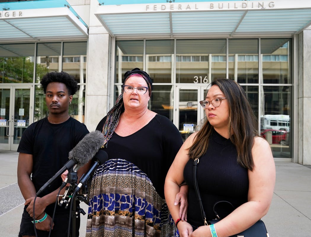 Joni Kueng, center, the mother of former Minneapolis police officer J. Alexander Kueng spoke Wednesday with Kueng’s brother Matthew Kueng, left, and a woman identified as Kueng’s significant other.