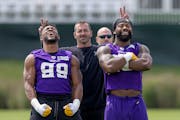 Danielle Hunter, left, and Za’Darius Smith struck a pose as Vikings outside linebackers coach Mike Smith fooled with them Wednesday at the TCO Perfo