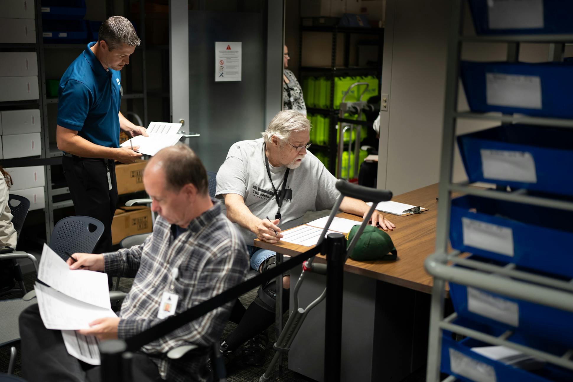 Ballot board judges Robert Wilson, foreground, a Democrat, and Republican Rick Klabechek, right, checked the results of the Anoka County vote test last week. Behind them was Anoka County elections specialist Tom Hunt.