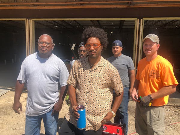 Chris Webley, center, is leading redevelopment project on the North Side. Helping are project manager Dwayne Etheridge of New Image Construction, left