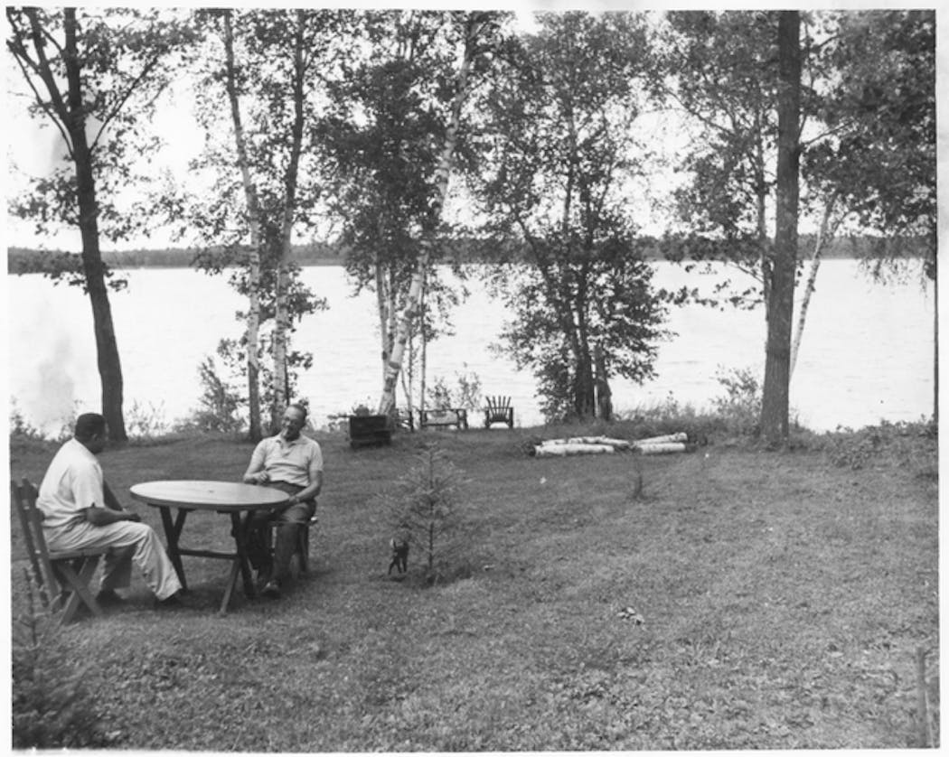 Two men chatted on the shores of Lake Adney in a photo taken around 1955.