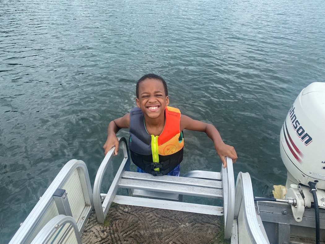 Malik Davis Jr. smiles for the picture on a recent boating excursion on Lake Adney.