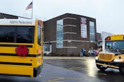 An electric school bus rolls into the parking lot at Brooklyn Middle School in the Osseo school district in November 2021. Osseo was one of five distr
