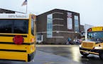 An electric school bus rolls into the parking lot at Brooklyn Middle School in the Osseo school district in November 2021. Osseo was one of five distr