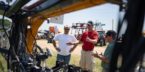 Adam Lund and Dustin Johnson looked around a precision spraying system at Farmfest on Tuesday, helped by Greeneye Technology’s Kody Paxton. Johnson 