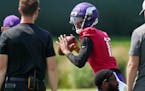 Kellen Mond participates in a passing drill during Vikings training camp.
