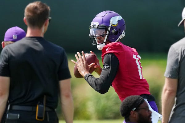 Kellen Mond participates in a passing drill during Vikings training camp.
