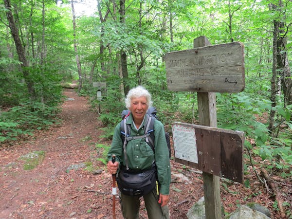 Joan Young, shown at the eastern terminus of the North Country Scenic Trail at Maine Junction, where it joins the Appalachian Trail in Vermont.