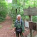 Joan Young, shown at the eastern terminus of the North Country Scenic Trail at Maine Junction, where it joins the Appalachian Trail in Vermont.