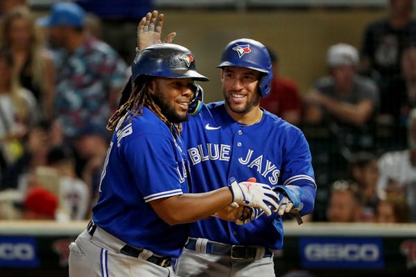 Vladimir Guerrero Jr., left, celebrated his three-run home run with Blue Jays teammate George Springer in the eighth inning of a 9-3 victory over the 