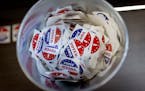 A bucket full of “I voted early” stickers sit near an exit door at the Minneapolis early voting center.