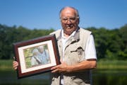 Chuck Delaney, owner and promoter of Game Fair, last week posed for a portrait with a photo of his wife Loral I, on the Game Fair grounds in Ramsey, M