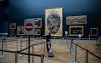 An employee cleans a room inside the Louvre Museum in Paris, Tuesday, July 26, 2022. The museum benefits from one of Paris’ best-kept secrets, an un
