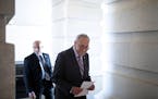 Senate Majority Leader Chuck Schumer (D-N.Y.) enters the Senate carriage entrance following a news conference on the Inflation Reduction Act at the U.