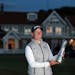 South Africa’s Ashleigh Buhai held up the trophy after winning the Women’s British Open in the fading sunlight on the fourth playoff hole against 