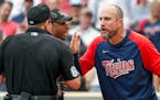 Minnesota Twins manager Rocco Baldelli, right, argues with umpires Marty Foster, left, and Alan Porter.