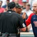 Minnesota Twins manager Rocco Baldelli, right, argues with umpires Marty Foster, left, and Alan Porter.