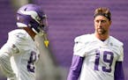 Minnesota Vikings wide receivers Bisi Johnson (81) and Adam Thielen (19) talk during the NFL football team's training camp at US Bank Stadium in Minne