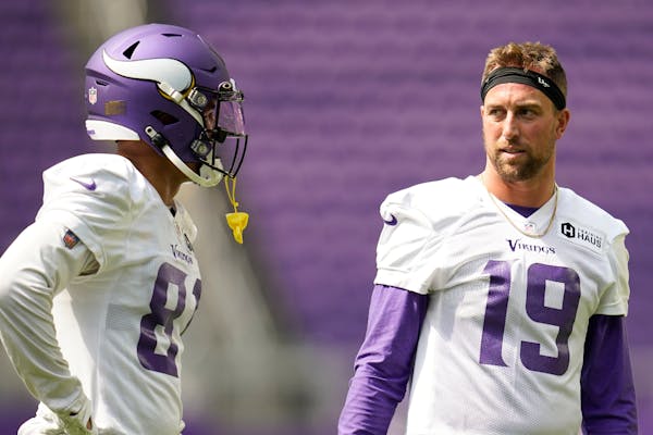 Minnesota Vikings wide receivers Bisi Johnson (81) and Adam Thielen (19) talk during the NFL football team's training camp at US Bank Stadium in Minne