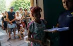 Residents waited in line to receive humanitarian aid at a distribution point in Kramatorsk, Donetsk region, eastern Ukraine, Tuesday, Aug. 9, 2022. 