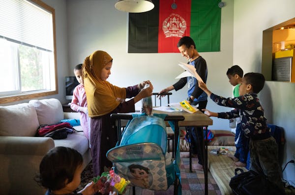 The Tayyeb children go through their summer school backpacks at their home in Minneapolis. The majority of students who participated in the Minneapoli