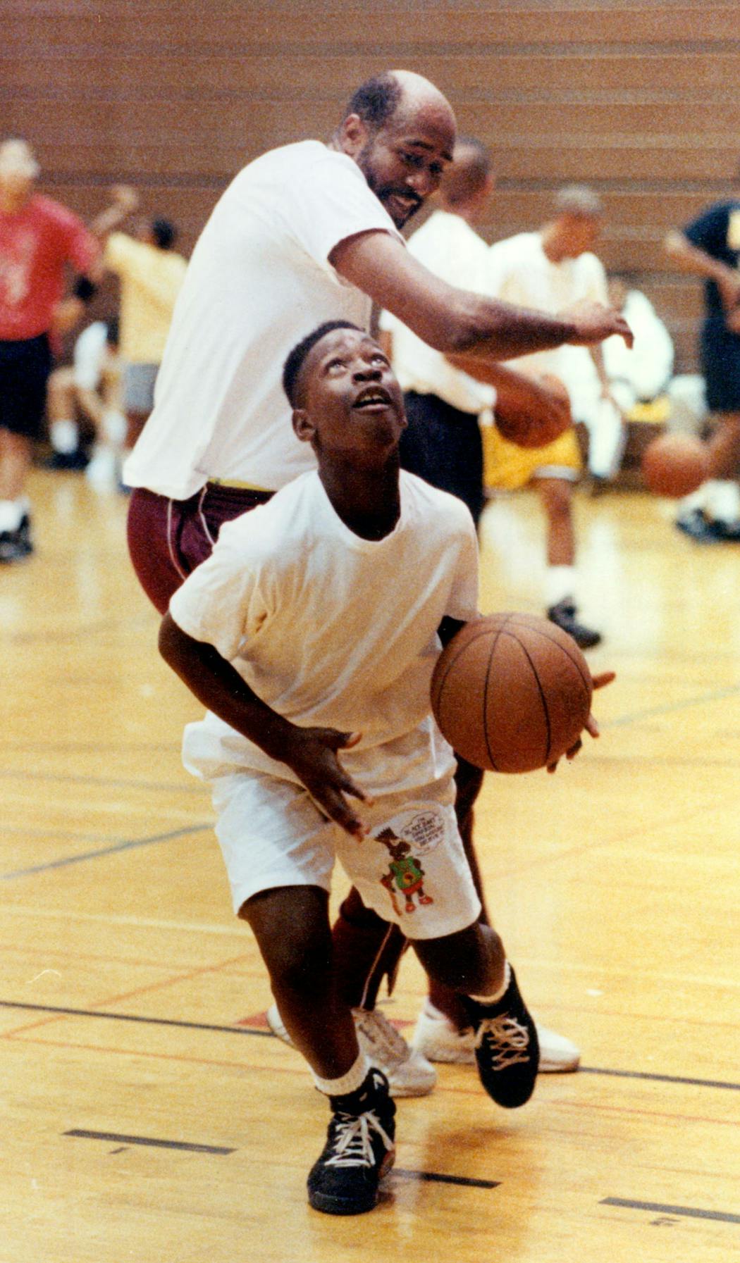 Clyde Turner kept this Star Tribune photo from 1991 prominently displayed, it shows Kolliepaye Kpowulu blowing past Turner for a layup during a camp session.