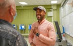 Mandela Barnes spoke with Gary Sprong as he places an “I Voted” sticker on his chest Tuesday, Aug. 9, 2022, during the partisan primary at Green T